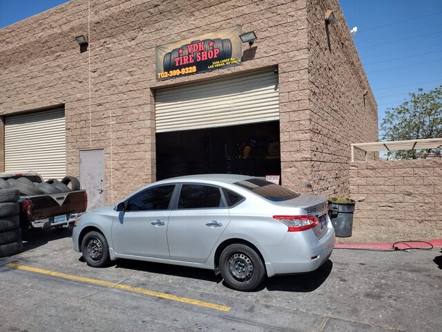 Silver Sedan Parked Tire Shop 040 — VDK Tire Shop