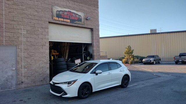 White Car Parked At Tire Shop 007 — VDK Tire Shop