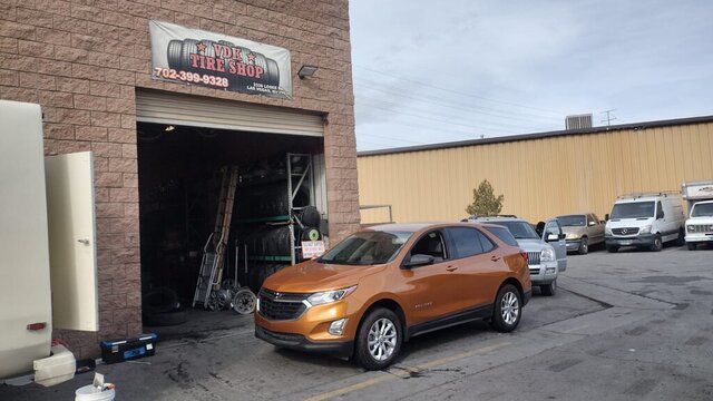 Orange SUV Parked Outside Tire Shop 012 — VDK Tire Shop