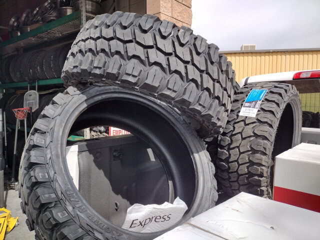 New mud terrain tires stacked at VDK Tire Shop