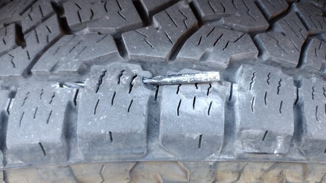 Nail puncture in tire tread requiring flat repair