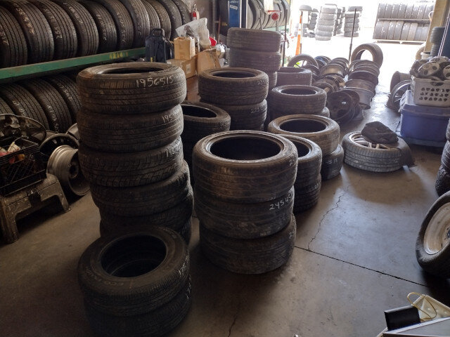 Used tires stacked in VDK Tire Shop garage