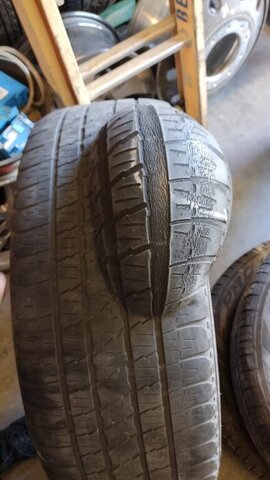 Checking tire tread wear during free air check at VDK Tire Shop