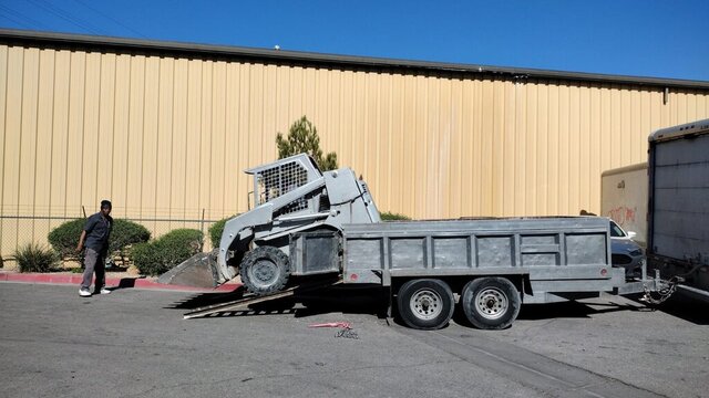 Skid Steer Loading Onto Trailer 001 — VDK Tire Shop